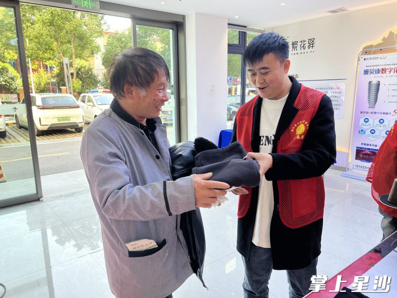 居民们接过缝补好的衣物开心地笑了。黄花镇供图