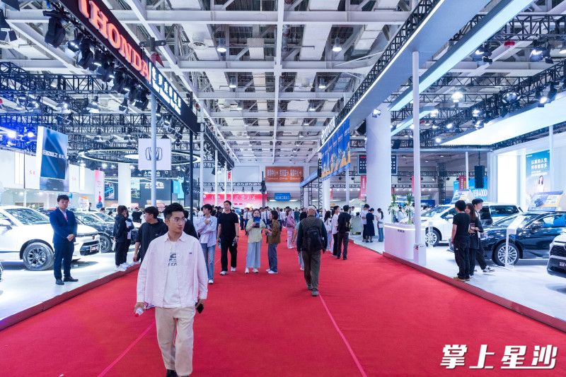 图为车展现场，市民在关注的品牌前逗留。