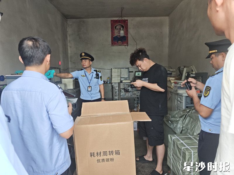 执法人员正对镇内一家涉嫌非法印刷的作坊进行查处。