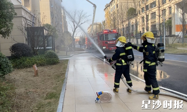 消防员在失火楼栋模拟开展灭火作业。均为王俊 摄