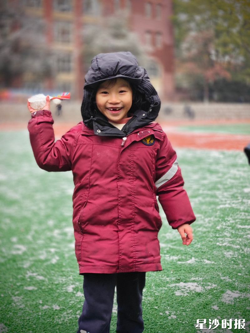 在湘珺未来学校，小朋友举着手里的小雪团，笑容像小太阳一样，把整个冬日的操场都照亮了。