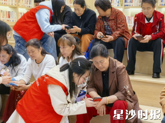 “薪火相传 智享银龄”智能手机和应用使用系列公益课程,工作人员热心指导老人们学习相关技能。
