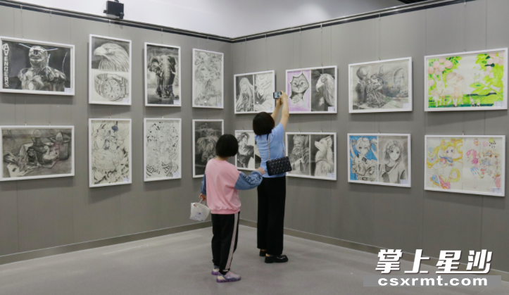 展厅的书画作品吸引市民拍照。
