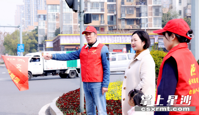 “志愿者诗人”虞志敏（左）参与交通文明劝导志愿服务。盛磊 摄