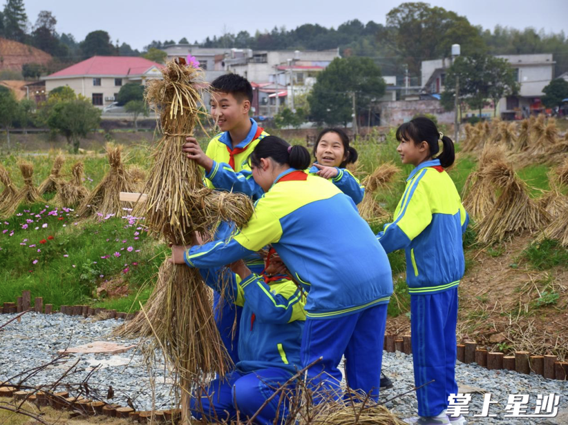 孩子们三五成群地围在一起扎稻草人。