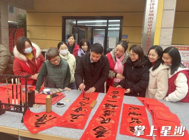 党员权家伟正在为小区居民写春联。均为泉塘街道供图
