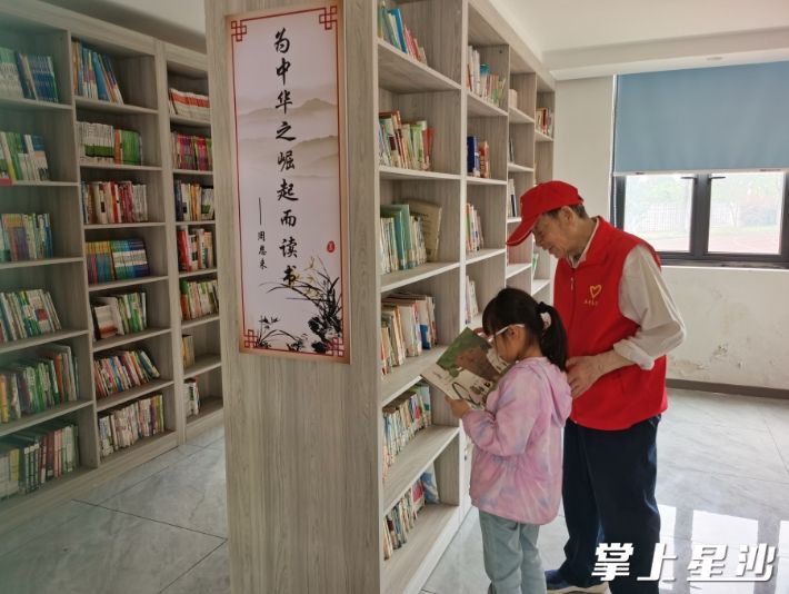高德福为学生做课后志愿辅导服务。黄兴镇供图
