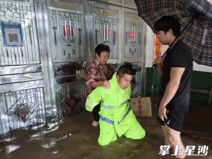 网格员程燚挨家挨户敲门，帮助村民转移。黄兴镇供图
