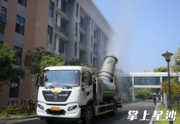 雾炮车正在长沙县松雅湖第二小学进行洒水降暑工作。杨欣雨 摄