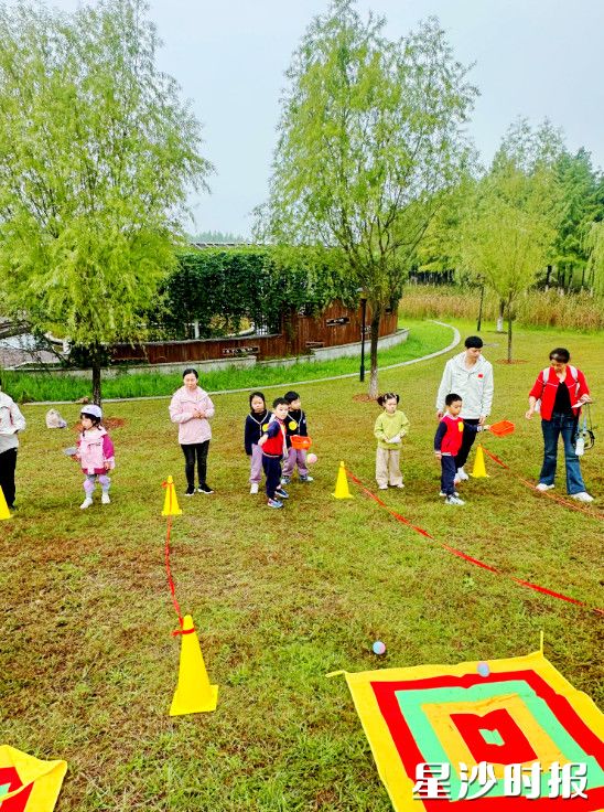图为幼儿园开展投石比拼游戏。