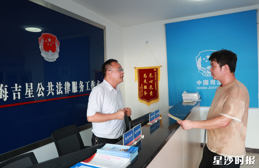 黄兴镇司法所所长周总强(左)给海吉星商户讲解合同条款相关法律知识。李杰 摄 黄兴镇司法所所长周总强(左)给海吉星商户讲解合同条款相关法律知识。李杰 摄